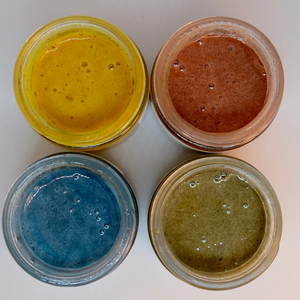 
                  
                    A set of 4 Loomis Hill Botanicals honey face masks, freshly poured showing vibrant yellow, pink, blue and green.
                  
                