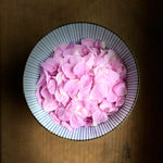A bowl of fresh rosa rugosa petals ready to be turned into this beautiful organic elixir.
