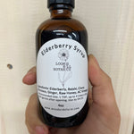 A bottle of Loomis Hill Botanicals elderberry syrup.